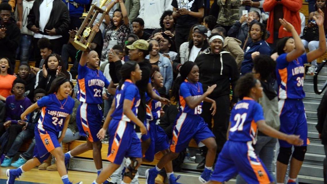 Central girls take a victory lap with their trophy in front of fans after beating Peach County at the buzzer.