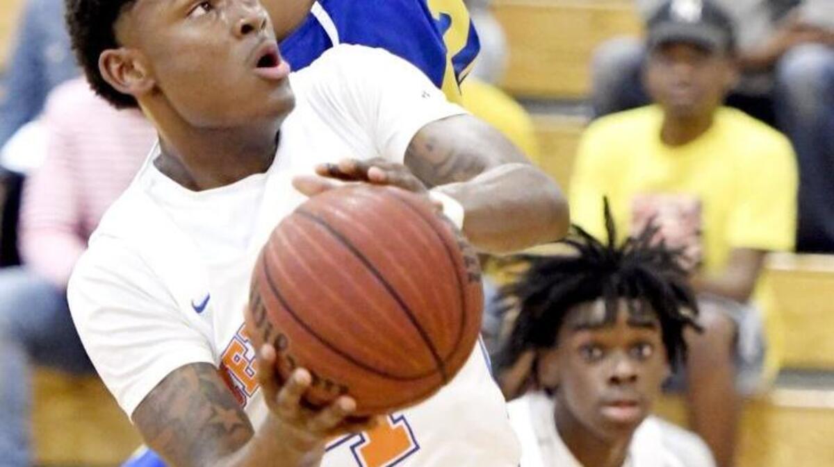 Central guard Kylan Hill (4) goes up for a shot in the lane Saturday during the Chargers' 67-39 first round GHSA 3A playoff win over Beach.