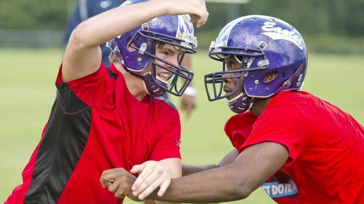 Crawford County defensive lineman Adam Morris fights off a block during an Eagles practice.