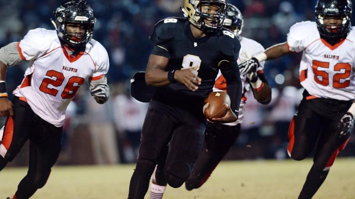 Mary Persons quarterback J.T. Hartage (8) reverses field as he runs into resistance from Baldwin’s defense and then sprints right all the way to the end zone for the Bulldogs’ first score in Friday’s game.