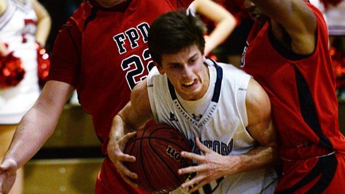 Stratford's Nathan Hunt (30) finds little room to shoot as FPD's Wesley Wilson (22) and Maurice Gordon (2) put on the defensive squeeze. FPD beat Stratford, 39-34.