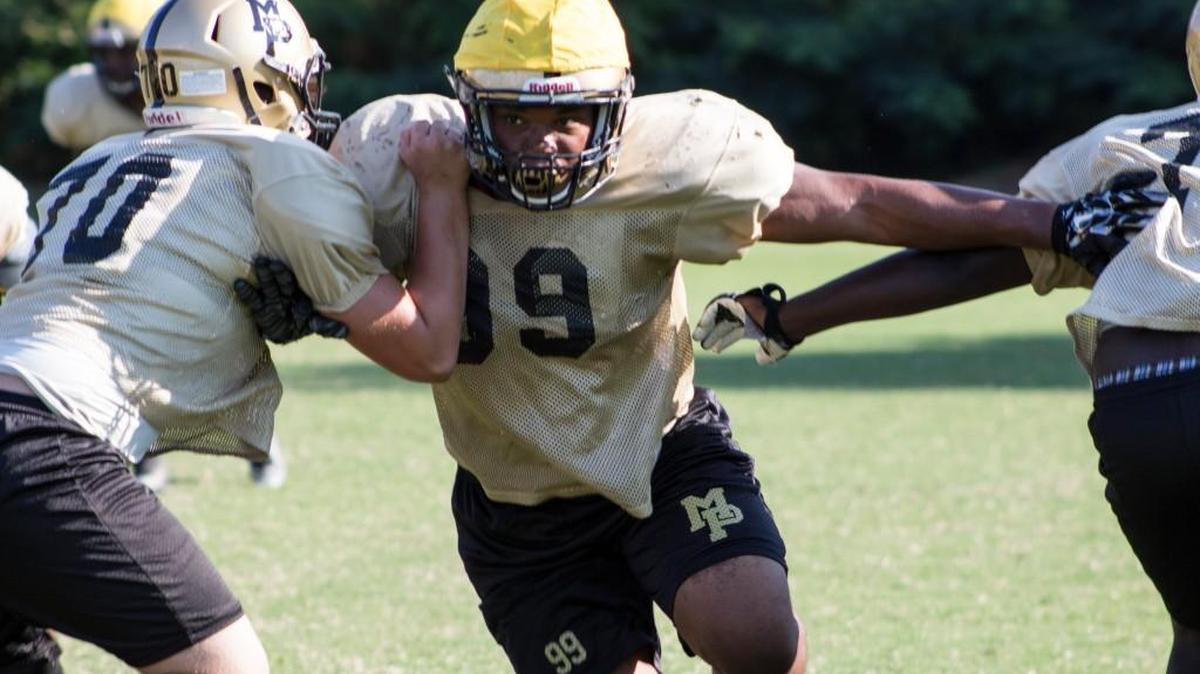 Mary Persons’ Derrick Goodson (99) pushes through his teammates during Wednesday’s practice.