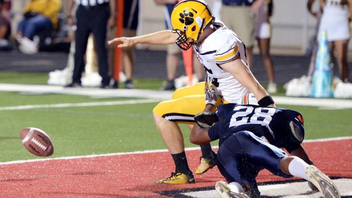 Northside defensive back Alijah McGhee (28) knocks the ball loose form Valdosta punter Davis Baldwin (45) during their game Friday night.