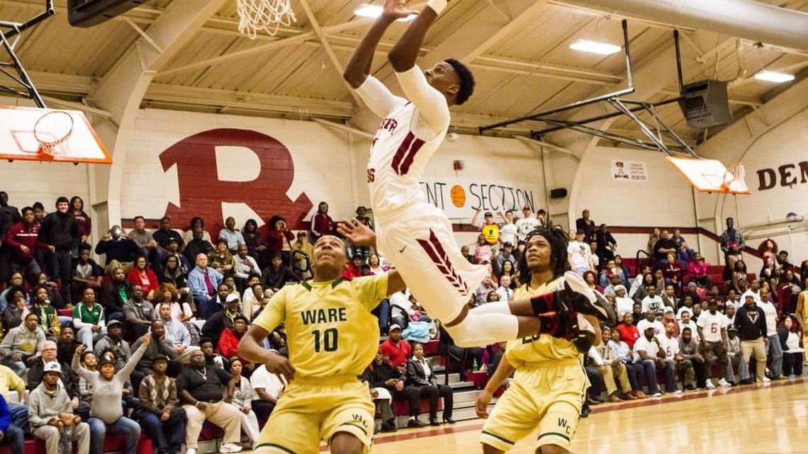 Nelson Phillips (10) drives to the basket for Warner Robins against Ware County in the first round of the GHSA Class AAAAA basketball playoffs.