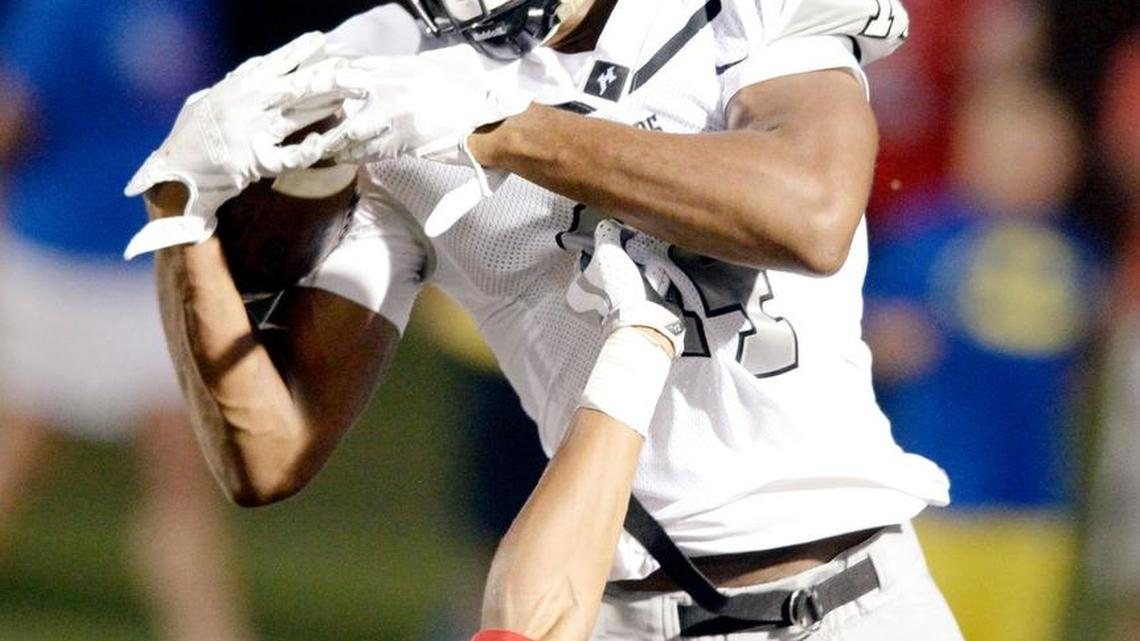 Houston County wide receiver Eli Watson (14) hauls in a touchdown pass from quarterback Jake Fromm during their game against Veterans.