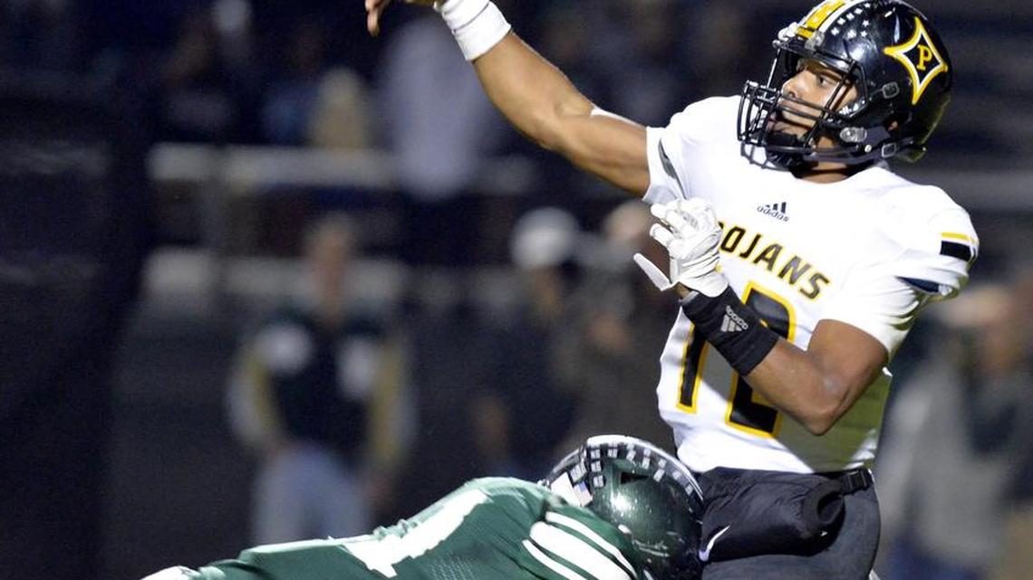 Peach County quarterback Antonio Gilbert (12) throws a pass downfield while being hit by a Westminster defender during their Class 3A quarterfinal game Friday night.