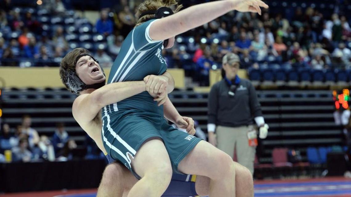 Mount de Sales wrestler Dane Frier, left, strains as he lifts and takes his Wesleyan School opponent to the mat Friday during the 2018 GHSA Team Dual Wrestling State Championships.