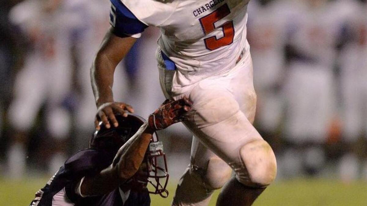 Central running back Antonio Sanders Jr. slips a tackle for a small gain in action Friday night against Southwest .