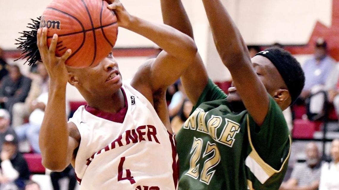 Warner Robins' Jacolbey Owens (4) puts up a shot in the lane Feb. 16 during the Demons' 96-63 win over Ware County.