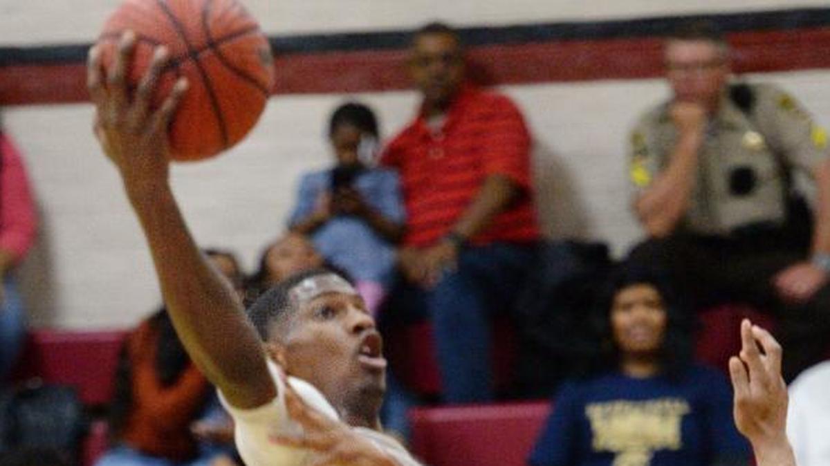 Warner Robins forward Nelson Phillips (10) drives toward the basket with a hook shot against Thomas County Central during a regular season game.