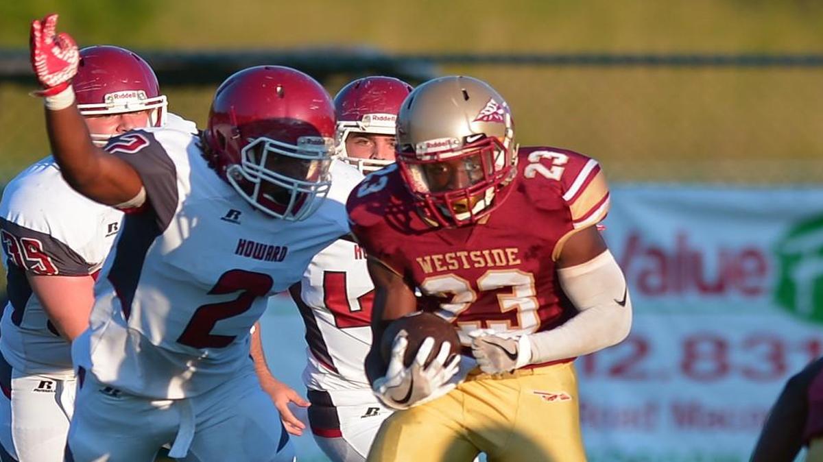 Westside running back Lake Lvin Clark finds a gap in in the Howard defensive line in action Friday night.