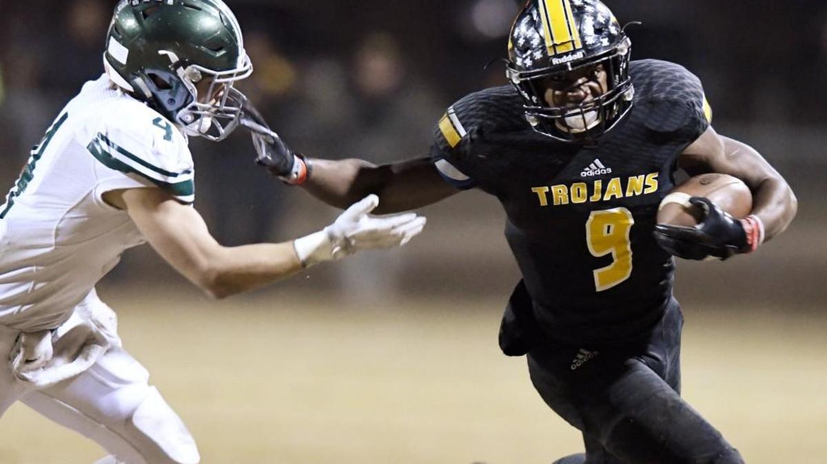 Peach County running back Trevon Woolfolk breaks away from Westminster's Joe Egan during their playoff game Nov. 24.