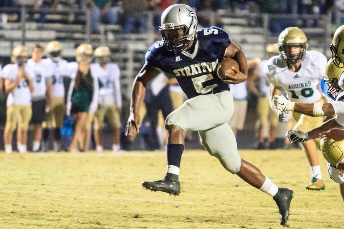 Stratford Academy’s Deondre Duehart (5) scores on a run up the middle against Aquinas on Nov. 3, 2017.