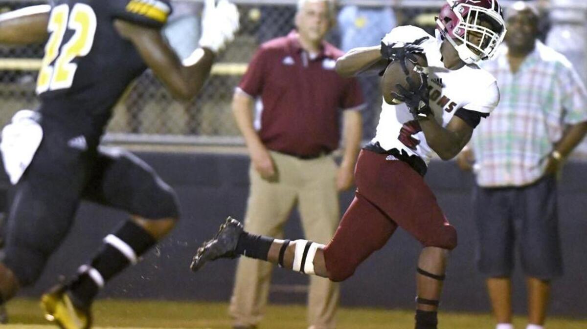 Warner Robins receiver Marcayll Jones (2) hauls in a fourth-quarter touchdown reception during the Demons’ win over Peach County on Friday night.