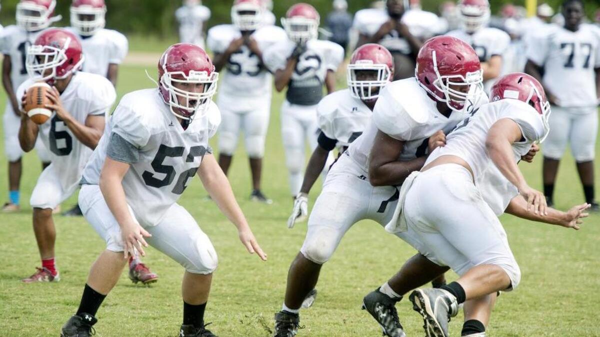 Howard guard Hayden Crosby (52) and tackle Gabe Howard (54) block for quarterback Avery Vining (6) during practice August 4.