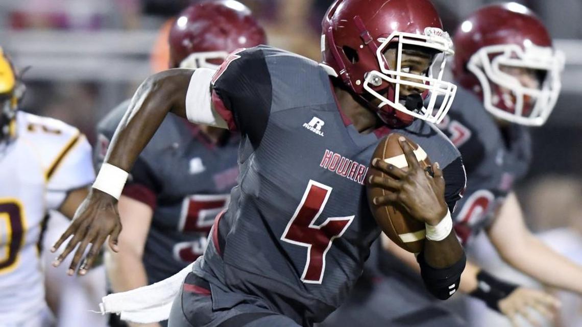 Howard's Quintin Sewell (4) runs threw a whole in the Perry defense during their game Thursday night.