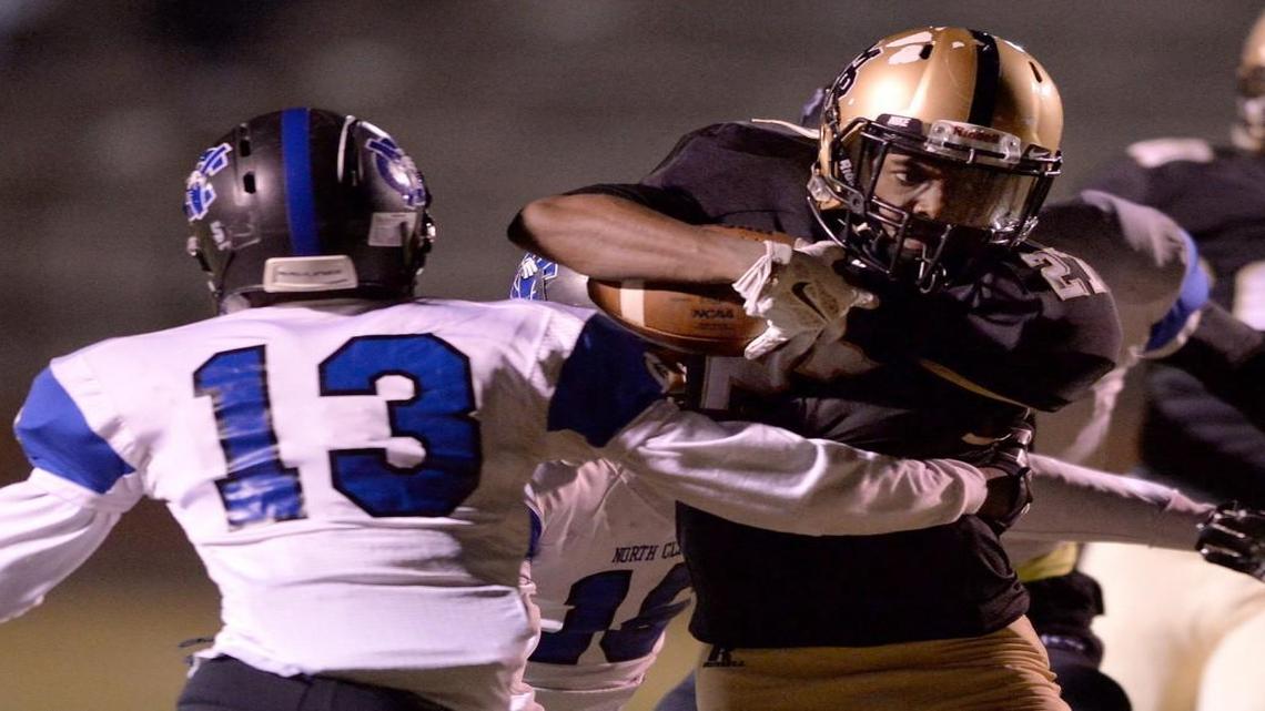 North Clayton defenders Marquel Parker (16) and Kyshaad Paige wrap up Mary Persons’ Quen Wilson after a 6-yard gain during the first quarter of their first-round game.