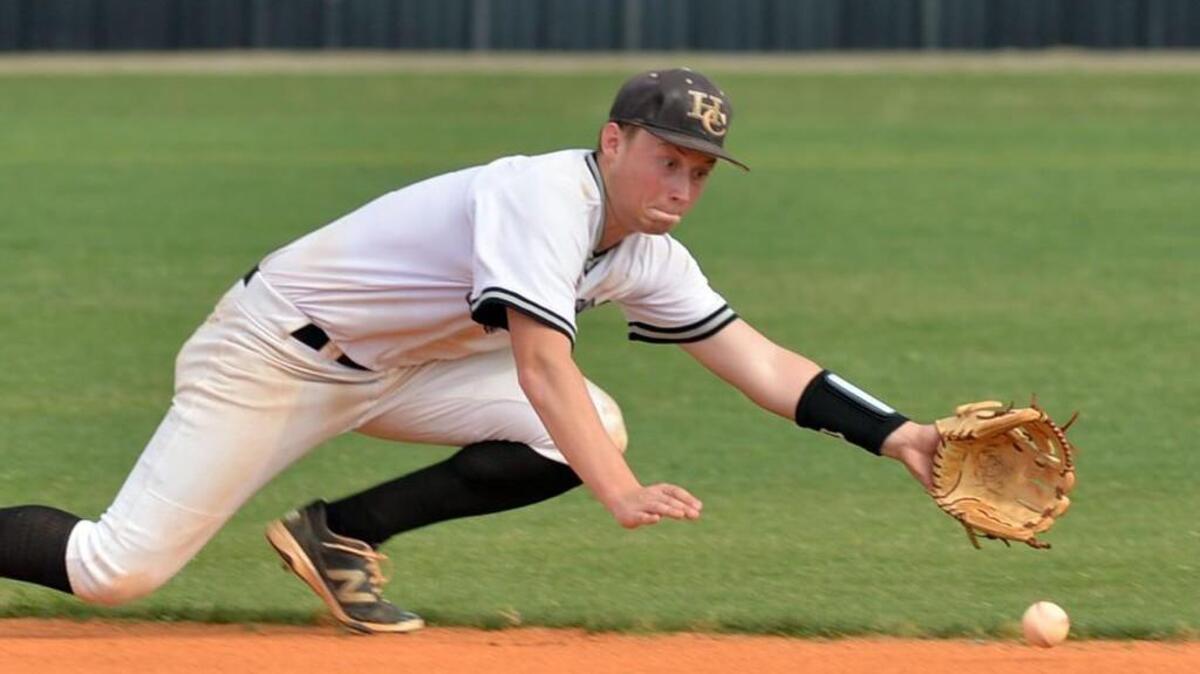 Houston County second baseman Dillon Strickland stretches for a grounder off the bat of Columbus’ Cason Greathouse during Tuesday’s GHSA Class AAAAA semifinal doubleheader.