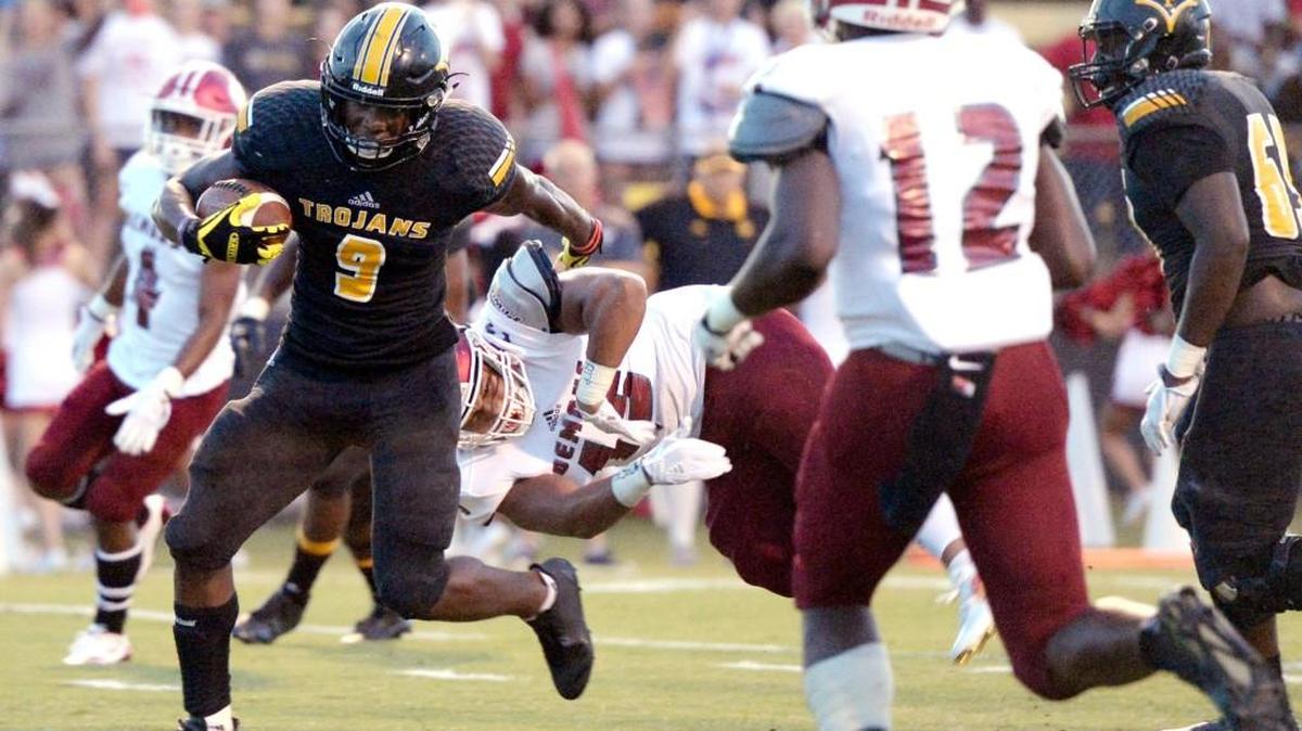 Peach County running back Trevon Woolfolk (9) breaks a tackle at the goal lone for a touchdown during the Trojans game against Warner Robins Friday night.