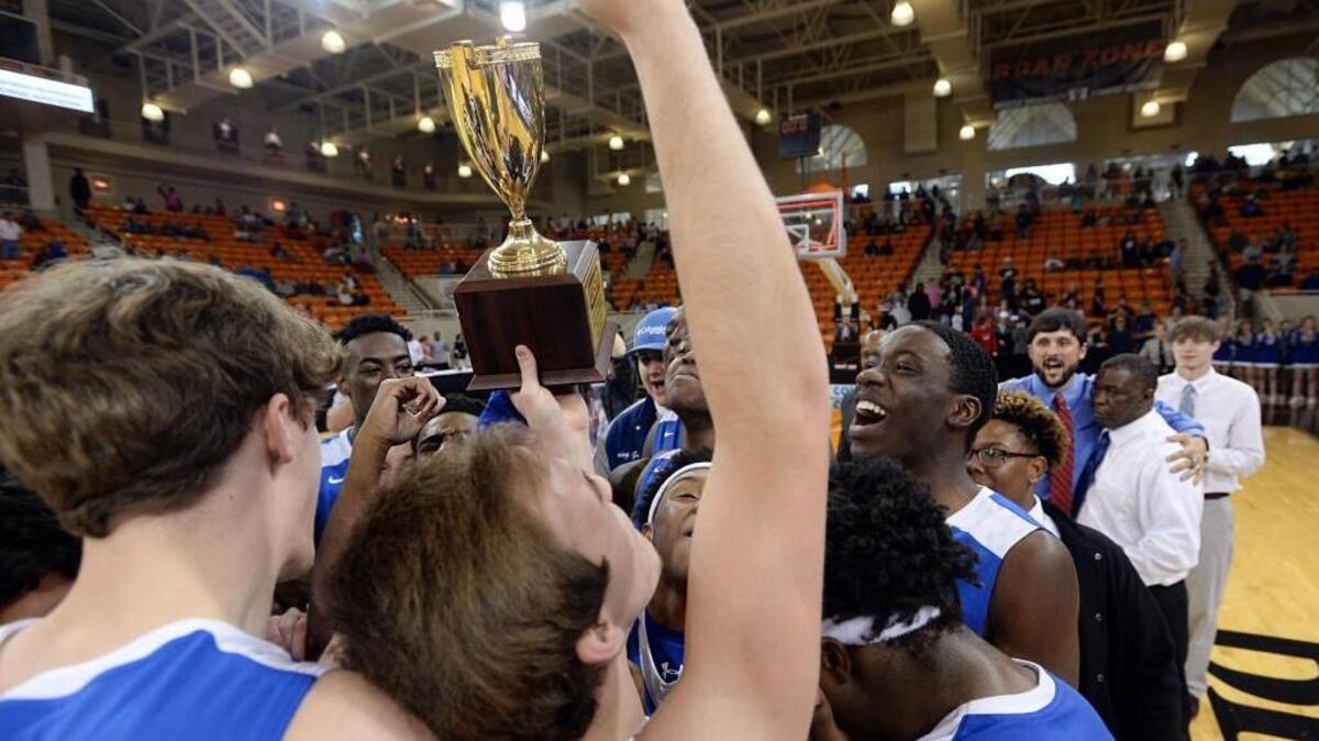 Windsor Academy hoists Class AA GISA state championship trophy after beating Furtah, 52-31.