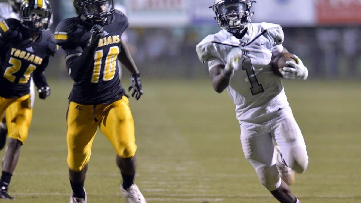 Houston County running back Jaeven West (1) runs 77-yds before being caught from behind by Peach County's Shamarcus Redding (10). Houston County beat Peach County, 49-31.