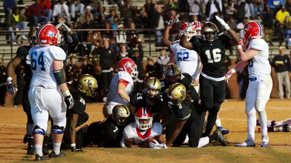 Bulldog defensive players Ladondre Buckner (7), Daniel Lavelle (24) and Tre Slaton (2) sack Jefferson’s quarterback for a safety Friday night.
