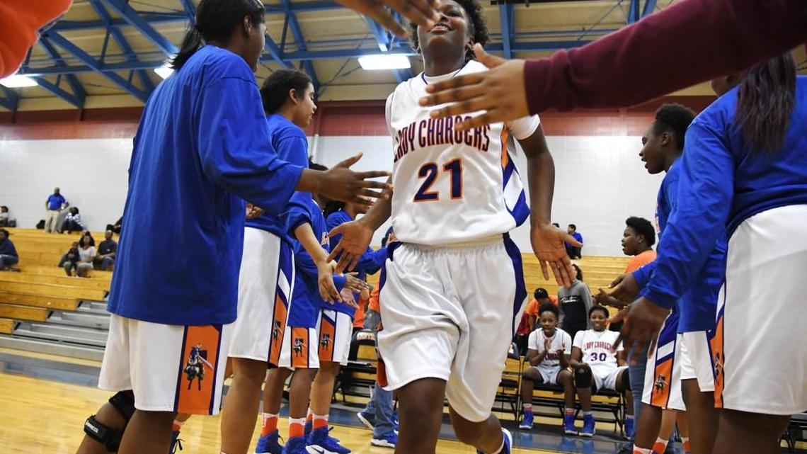 Central's girls basketball player Tyleia Williams (21) runs onto the court as she is introduced to the crowd before their game against Beach Tuesday.