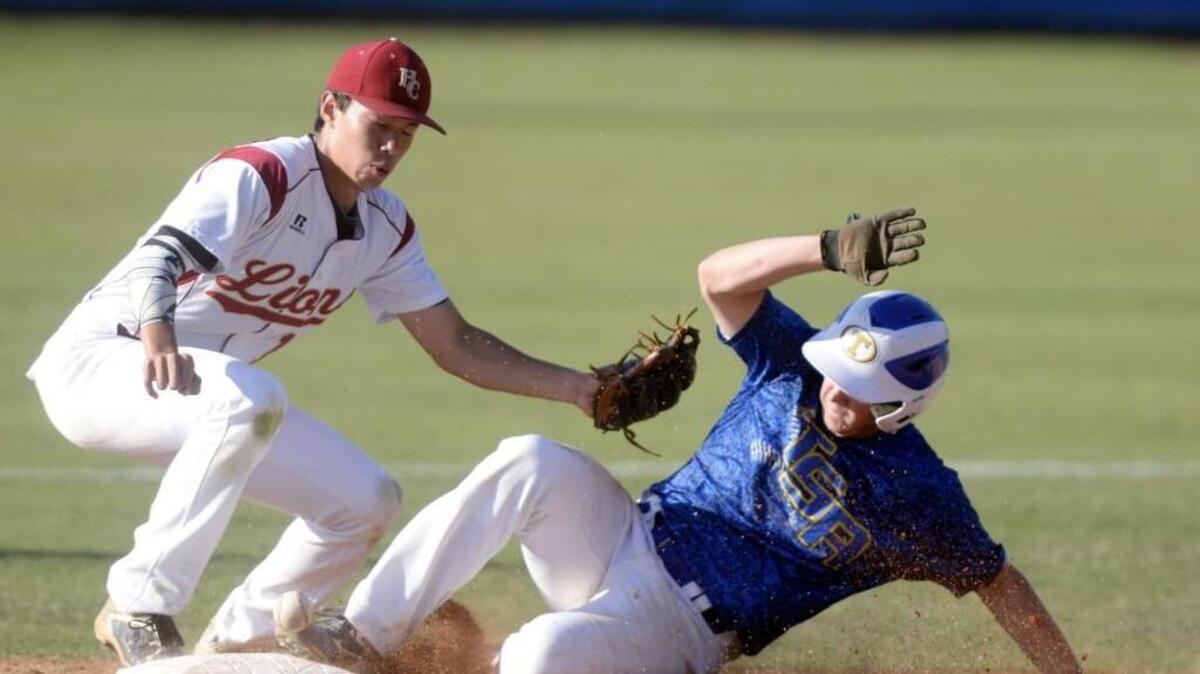 Hebron Christian shortstop Steven Casey, left, can't scoop up the ball as Tattnall Square’s Cory Bartholomew safely steals second base during Game 2 of their GHSA championship series Saturday afternoon.