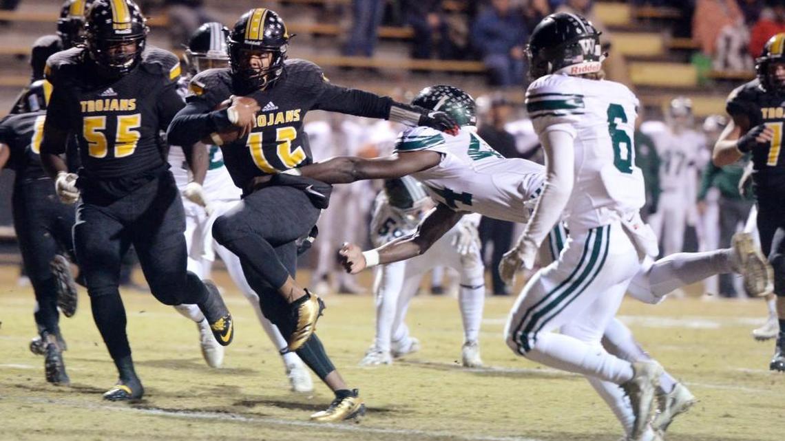 Peach County quarterback Antonio Gilbert (12) breaks a tackle for a touchdown against Westminster during their playoff game Friday night.
