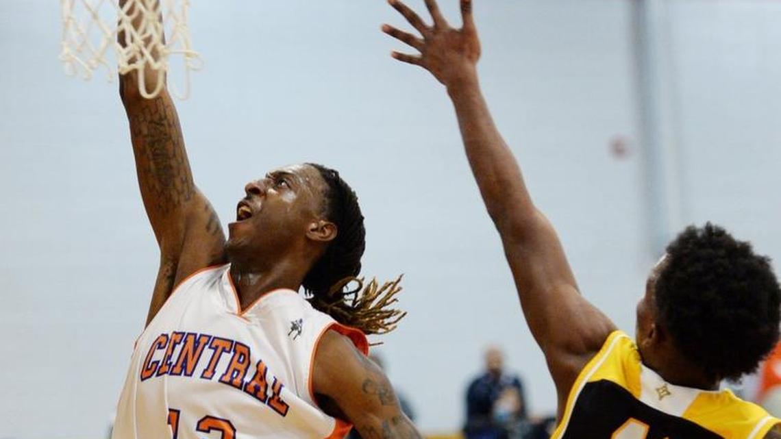 Central’s Antarius McCoy (12) moves by Peach County’s Jalen Manuel (11) for a first-half basket. Central beat Peach County, 87-56.