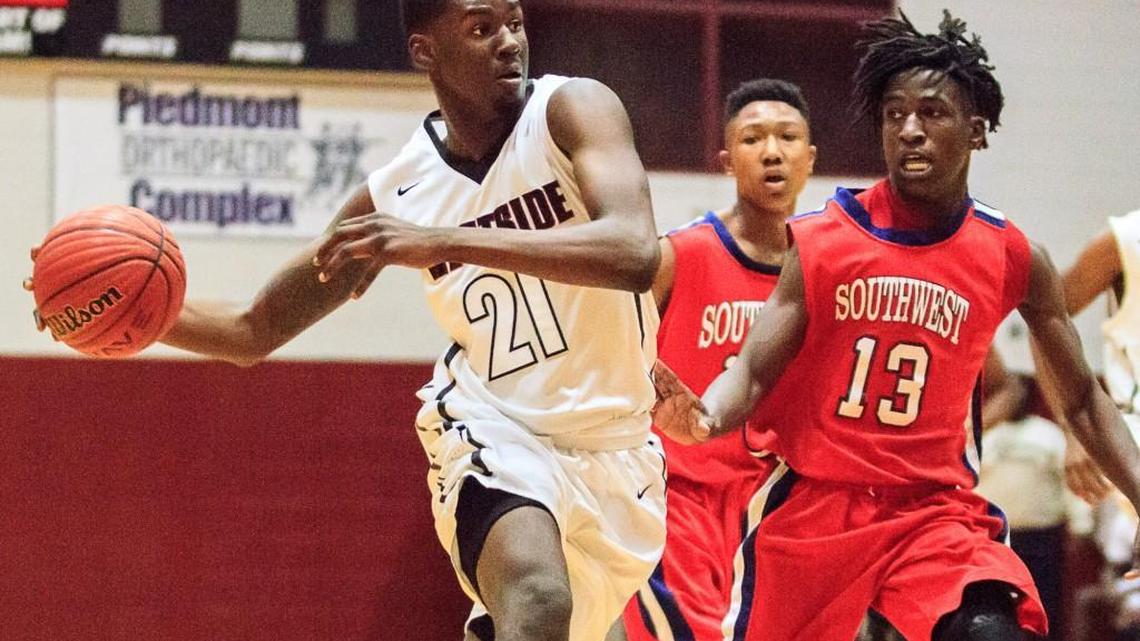 Westside's Khavon Moore (21) drives into the lane past Southwest's Tyrese Evans (13).