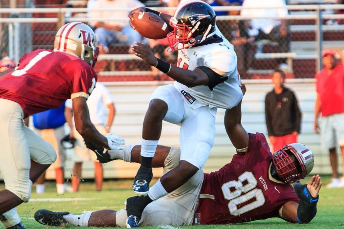 Southwest's Jordan Slocum (11) tackled for a loss by Westside's Allen Banks (80) in the 1st half of their game Friday night.