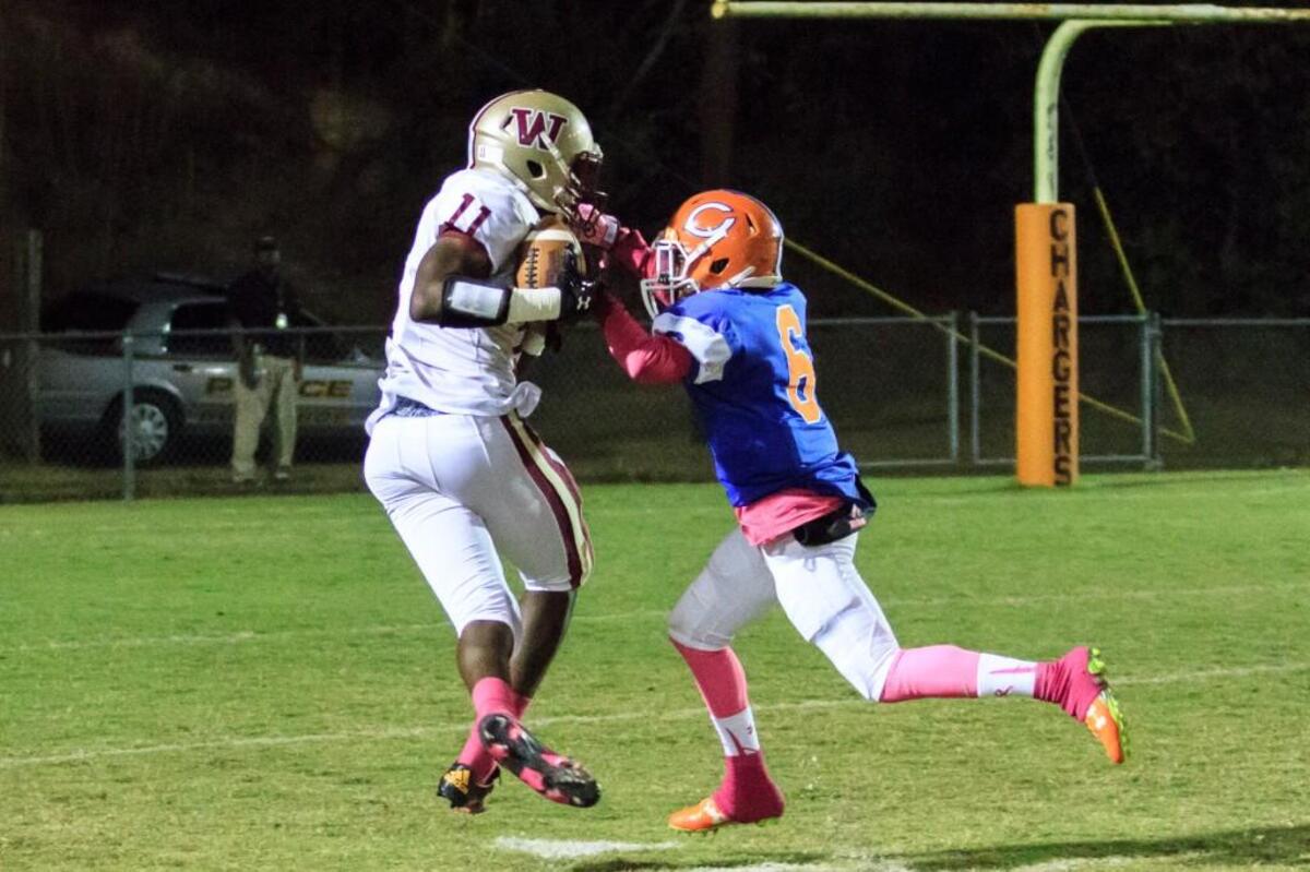 Westside's Omar Jones (11) scores a touchdown after fighting Central's Zavion Muhammad (6) for possession of a pass in the 1st half of their game.