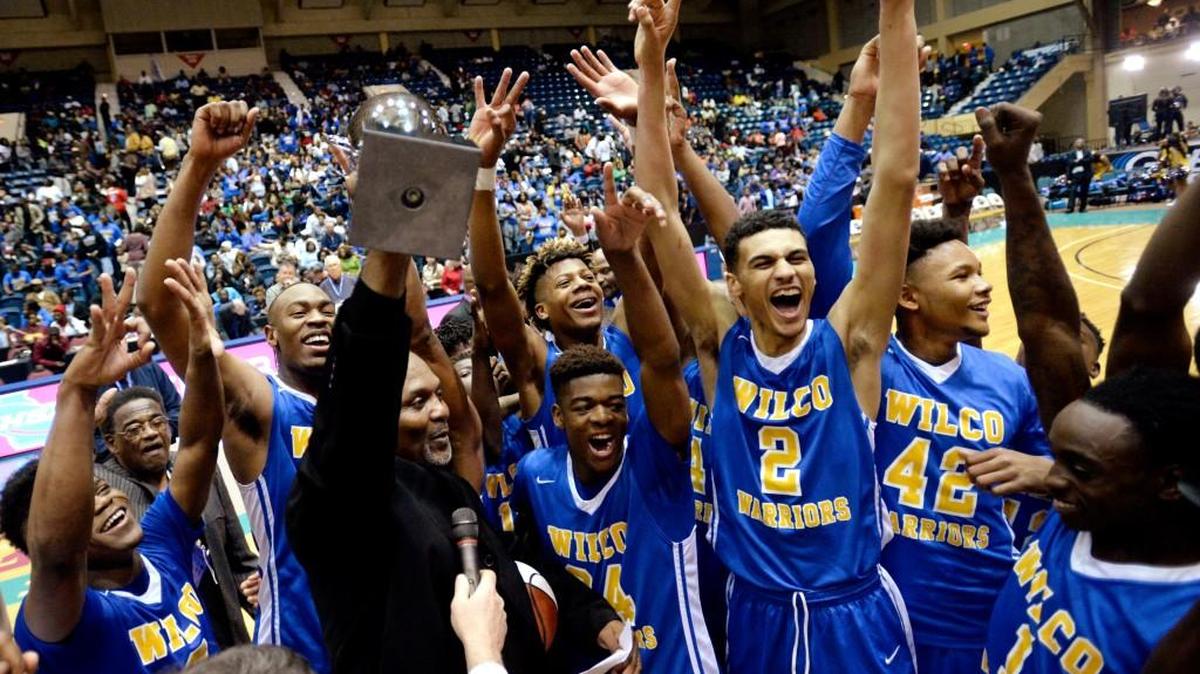 Wilkinson County head coach Aaron Geter celebrates with his team after their GHSA championship win over Hancock Central.
