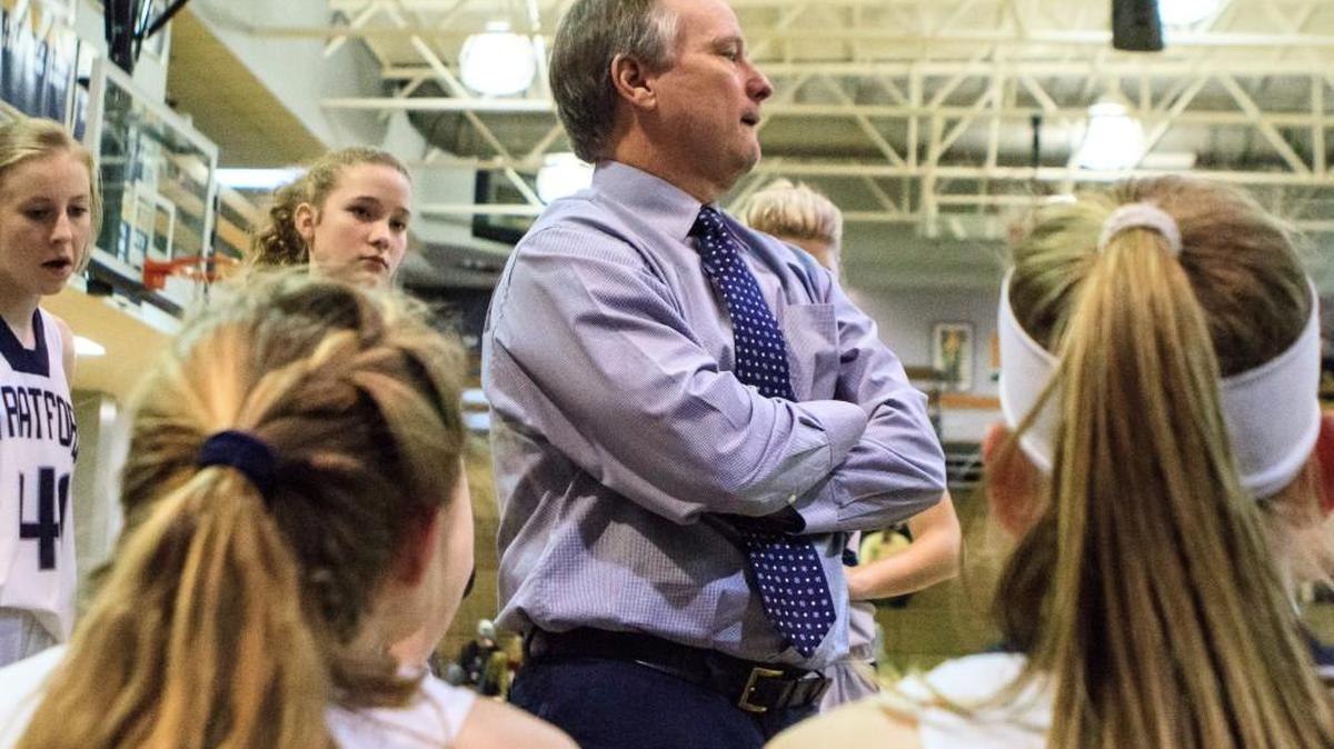 Stratford Academy girl's basketball head coach Ed Smith was surrounded by team members during a game against Mount de Sales on Wednesday.