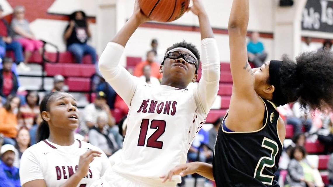 Warner Robins' Le'terria Mathis (12) puts up a shot during their first round playoff game against Morrow Friday night.