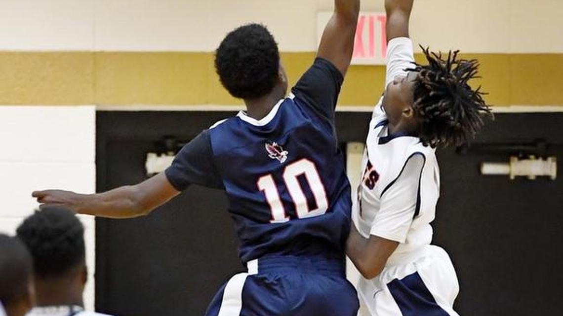 Northside’s C.J. Smith (22), finishes off a forced turnover with a layup over Putnam County’s Rodney Daniels (10) at the Mary Persons Holiday Classic on Thursday.