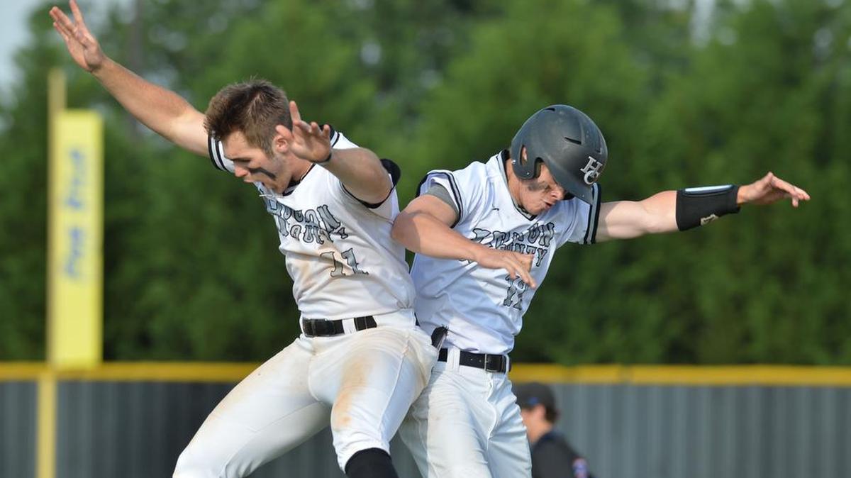 Houston County's Jake Fromm (11) and Austin Hittinger bump after Hittinger’s game winning smash to the left-field fence scored the winning run in the bottom of the seventh in Game 1 against Columbus on Tuesday.