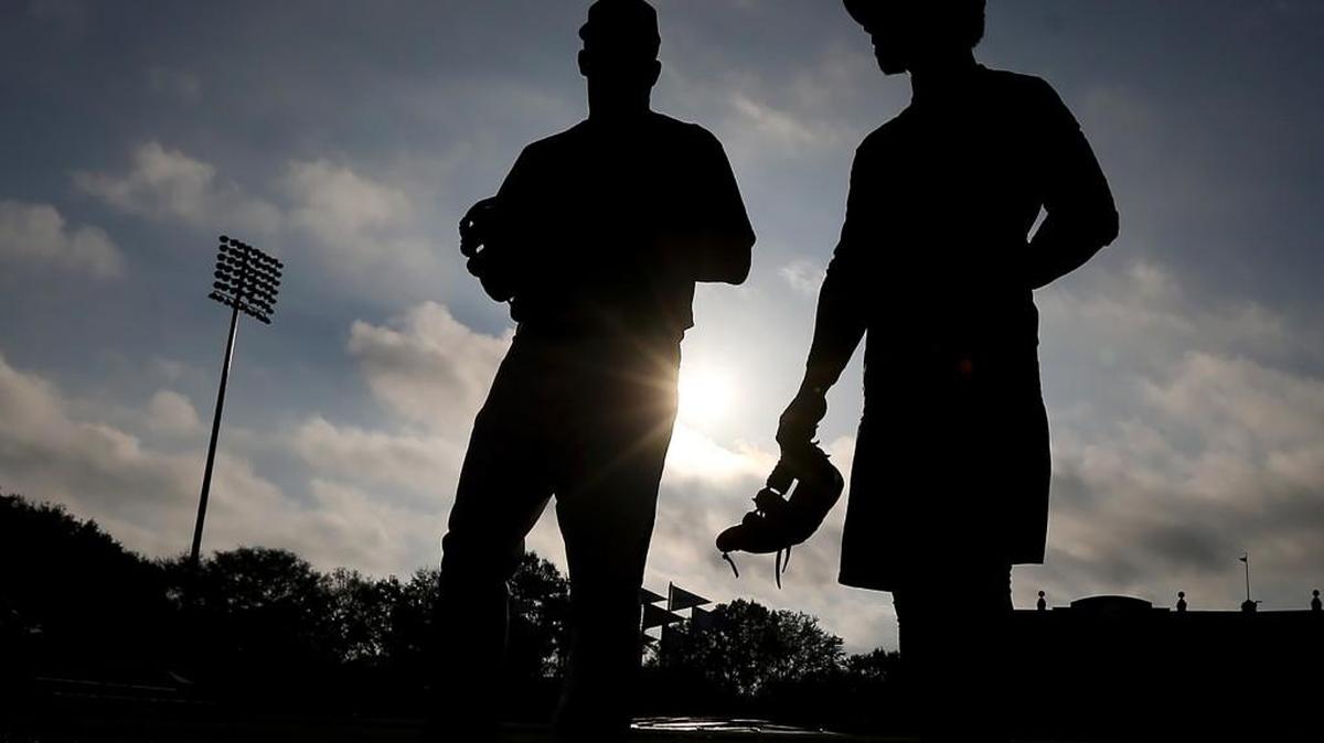 Atlanta Braves infielder Ozzie Albies gets an early start at sunrise working with coach Paul Runge in Champion Stadium as the Braves pitchers and catchers prepare to hold their first workout Wednesday in Lake Buena Vista, Florida.