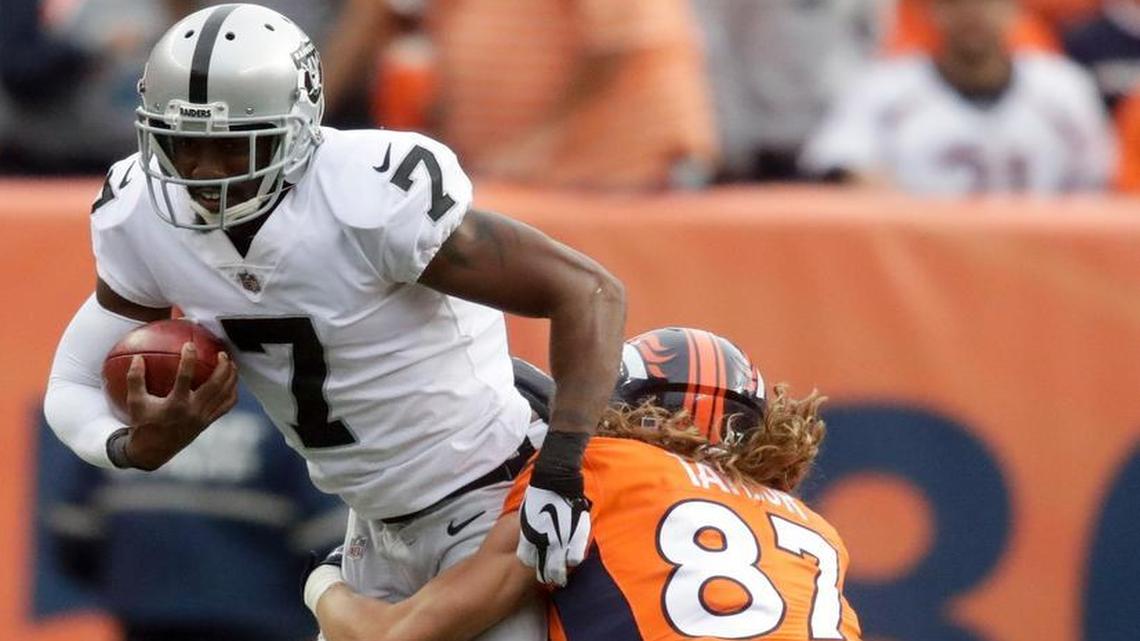 Oakland Raiders punter Marquette King is tackled by Denver Broncos wide receiver Jordan Taylor during Sunday’s game.