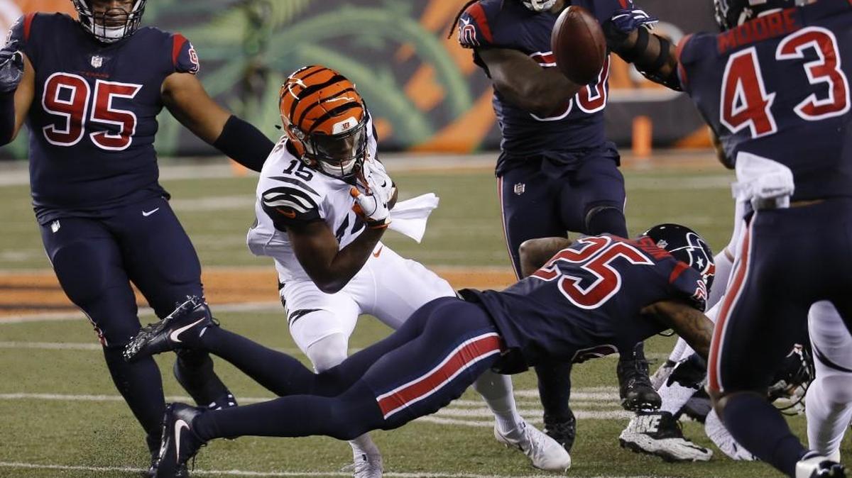 Houston Texans cornerback Kareem Jackson (25) forces a fumble by Cincinnati wide receiver John Ross on Thursday.