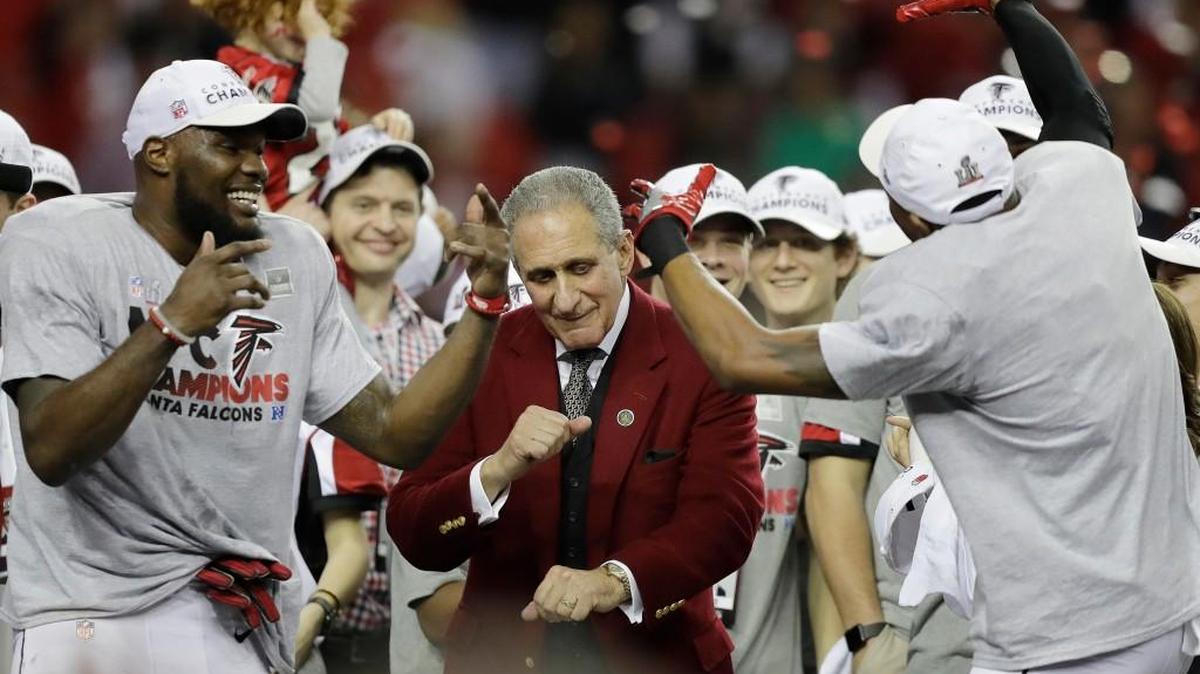 Atlanta Falcons owner Arthur Blank dances with players after the NFL football NFC championship game against the Green Bay Packers, Sunday, Jan. 22, 2017, in Atlanta. The Falcons won 44-21 to advance to Super Bowl LI.