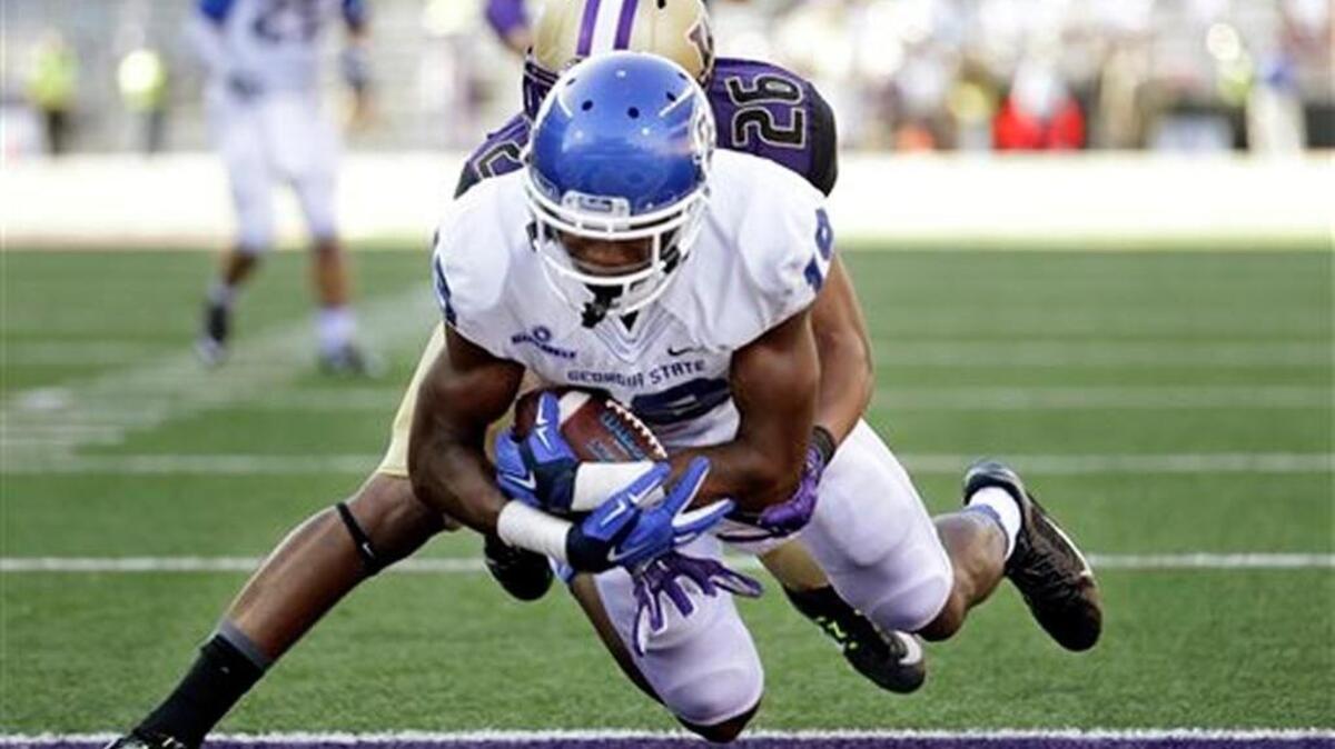 Georgia State's Robert Davis dives into the end zone on a 9-yard touchdown reception as Washington's Sidney Jones defends in a 2014 game. Davis had four catches and a touchdown in the loss.