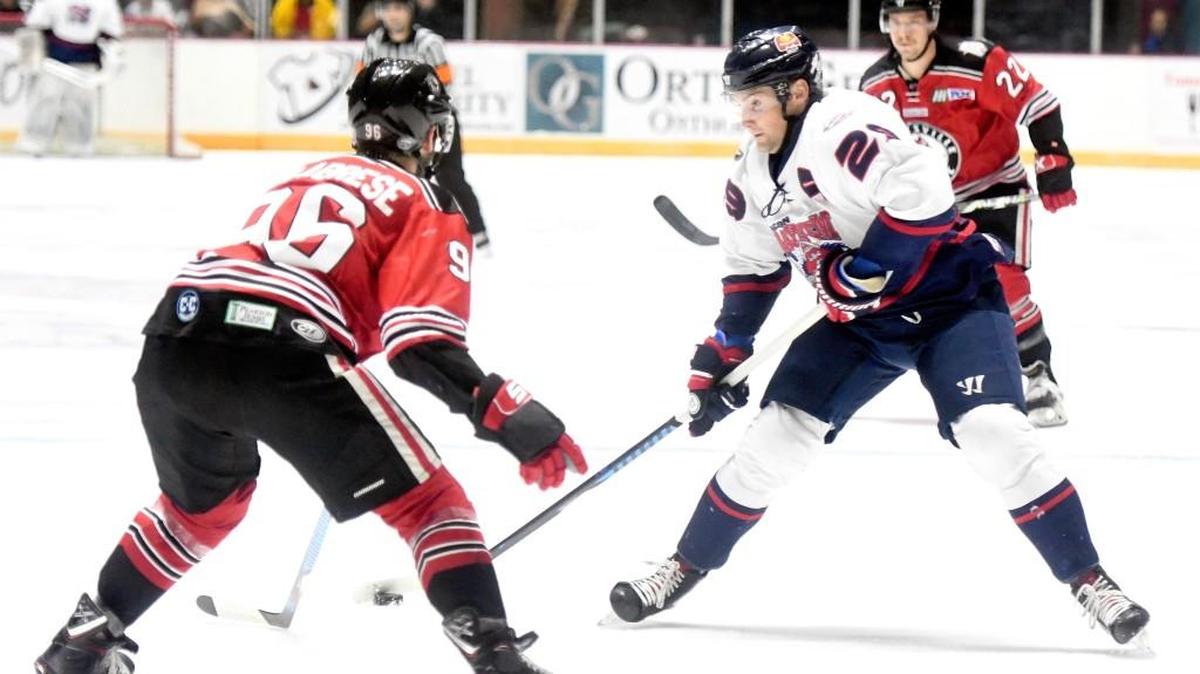 Mayhem left winger Jake Trask (29) is defended by Huntsville’s Anthony Calabrese (96) Friday night during game 3 of their SPHL semifinal series.