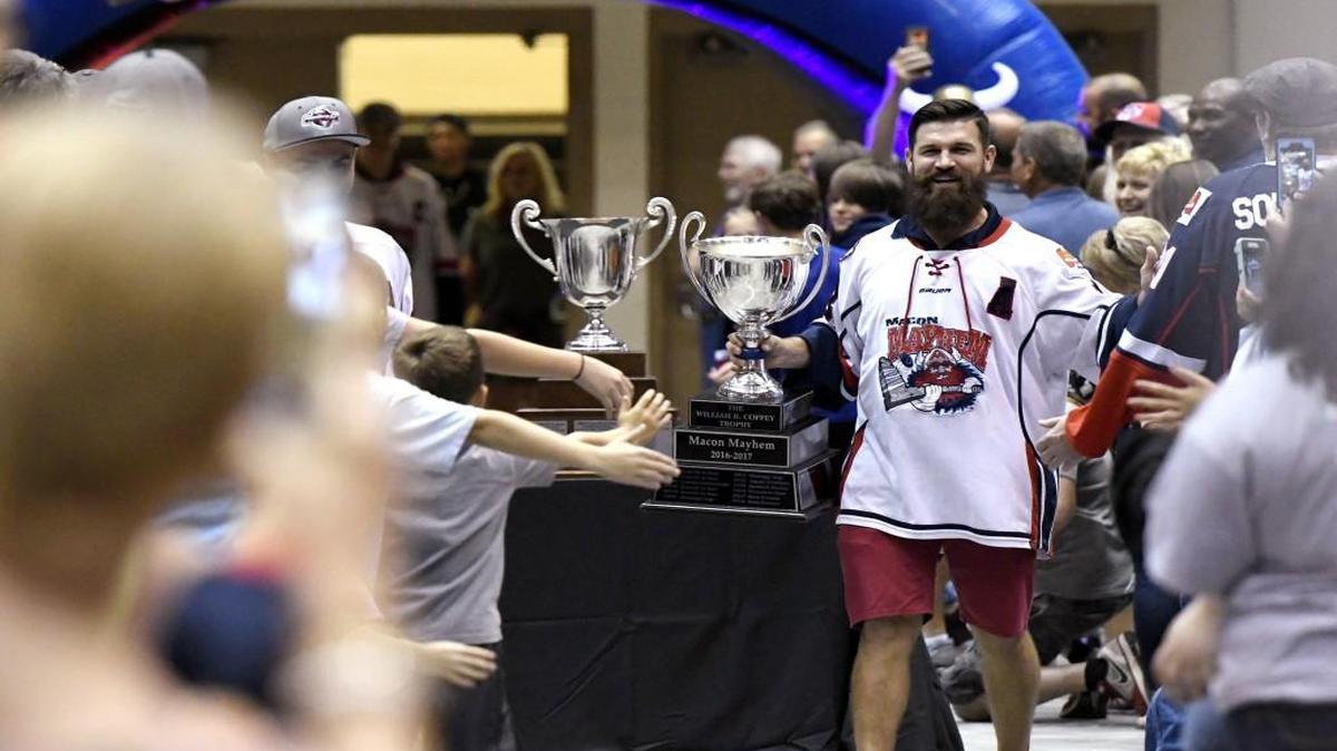 Macon Mayhem’s Dennis Sicard shows off the William B. Coffee Trophy to fans during a championship celebration Tuesday night at the Macon Coliseum.