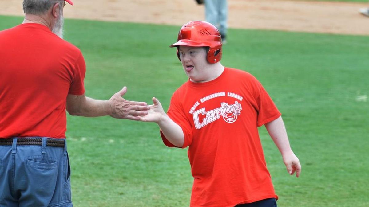 Jonathan Murphy, right, gets a high-five after his RBI single in a 2014 Challenger Division game.