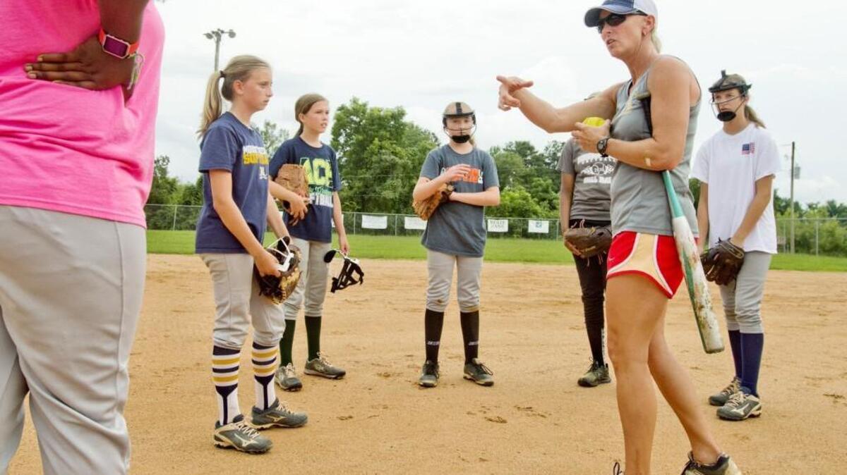 Vine Ingle Little League softball head coach Katherine Smith speaks with her team during practice Sunday.