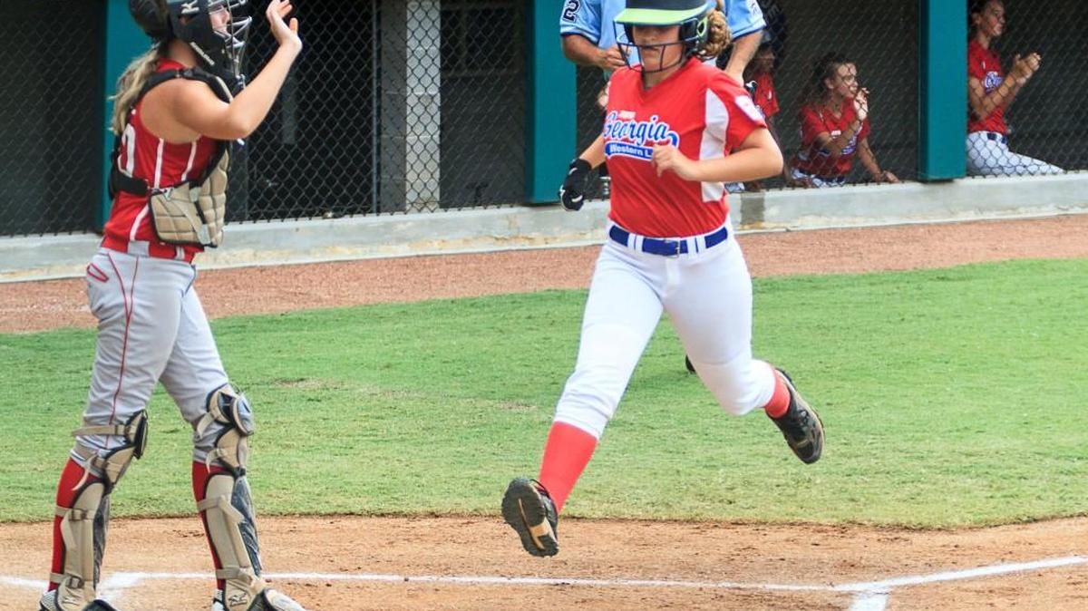 Georgia’s Henderson Hurdle, right, scores a run against West Virginia in the Little League Southeastern Regional on Saturday.