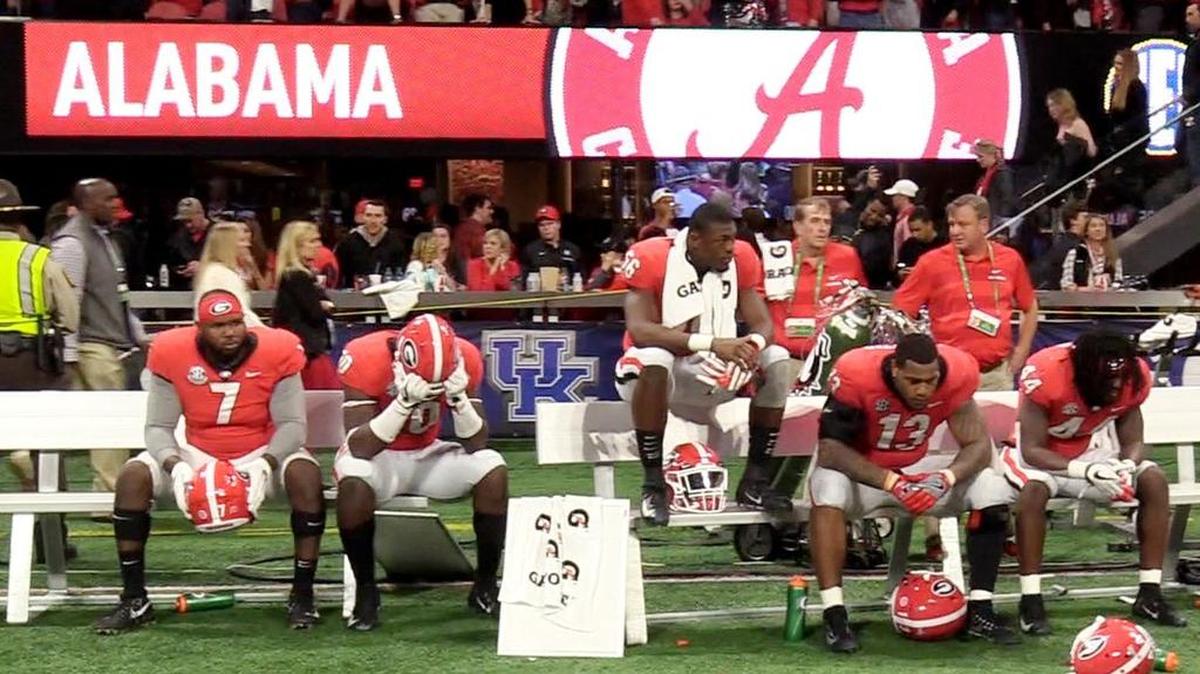 Georgia players sit on the bench after their 35-28 loss to Alabama in the SEC Championship game in Atlanta Saturday.