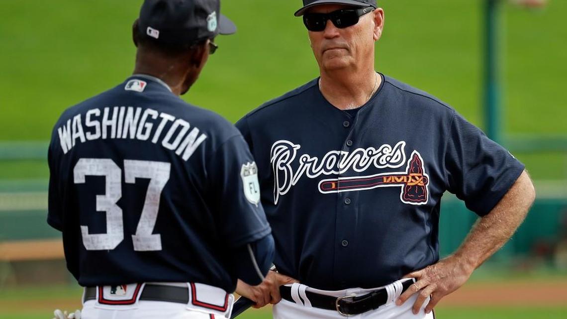 Atlanta Braves manager Brian Snitker, right, talks with third-base coach Ron Washington during a spring training baseball workout.